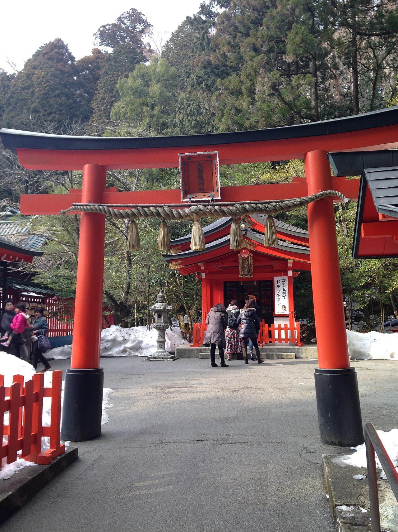 The iconic red torii gate of Hakone Shrine partially submerged in Lake Ashi
