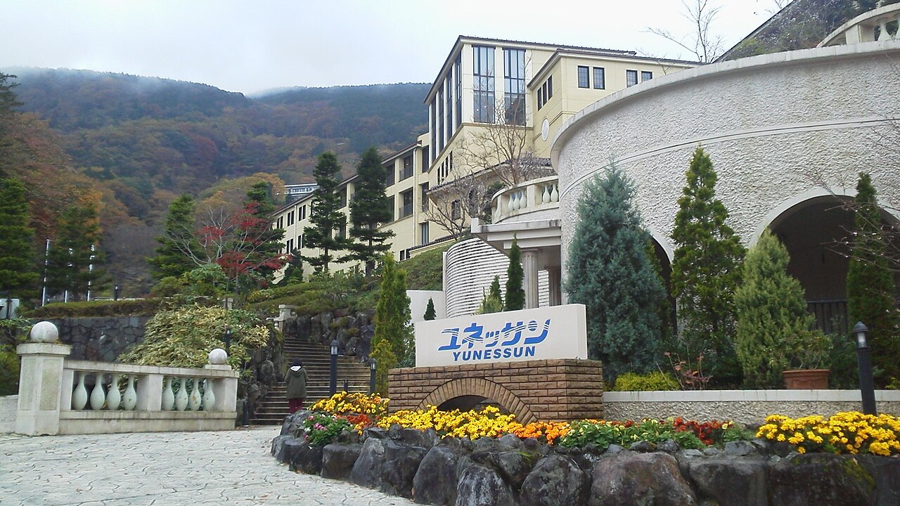 Families enjoying the indoor pools and attractions at Hakone Yunessun water park.
