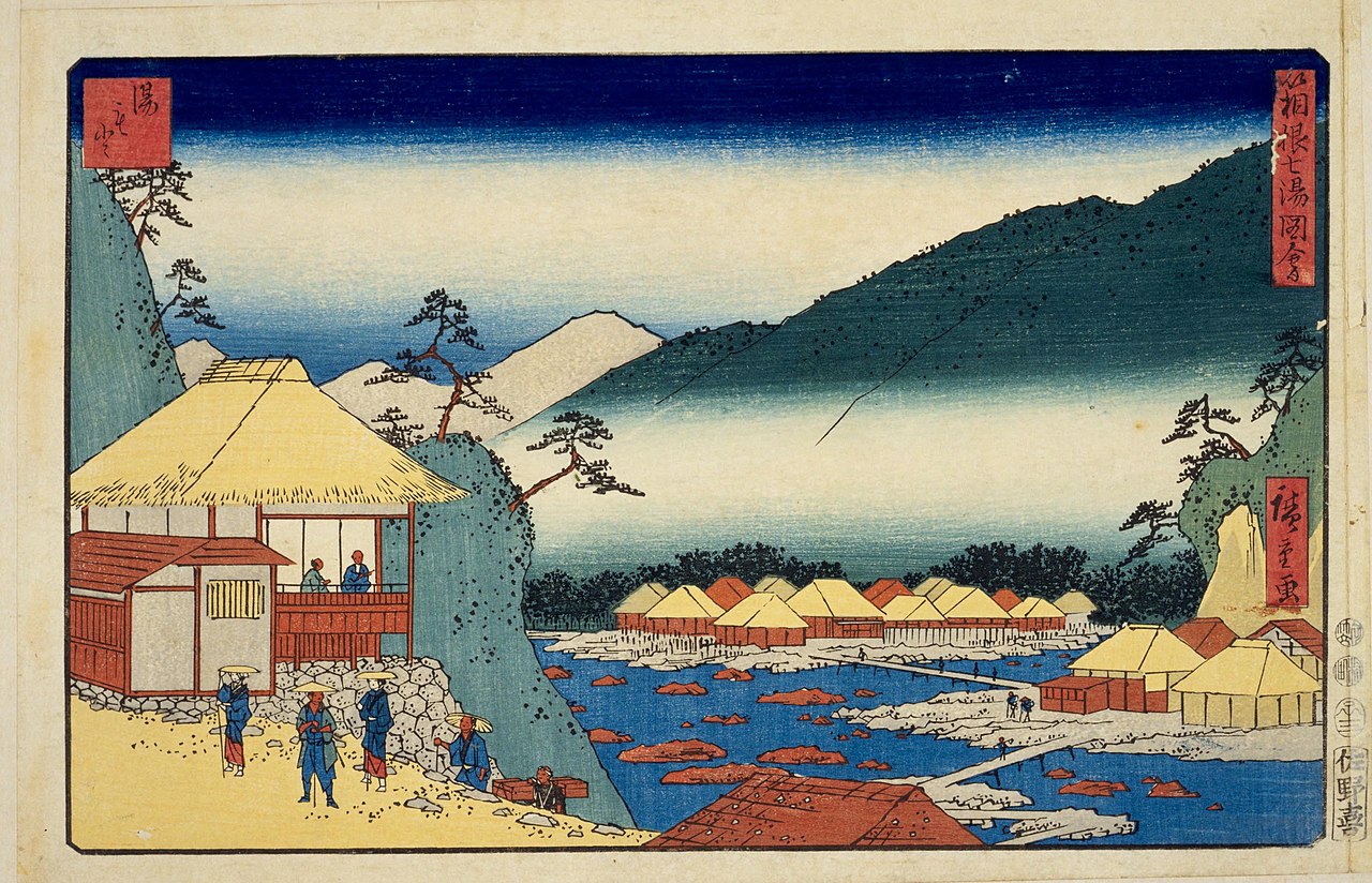 Traditional outdoor onsen bath in Hakone-Yumoto, surrounded by lush greenery