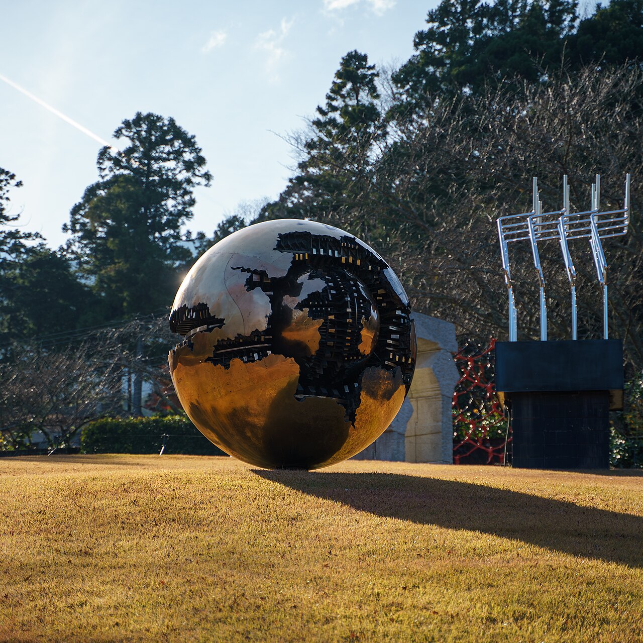 A wide shot of various outdoor sculptures set against the Hakone mountains at the Open Air Museum.