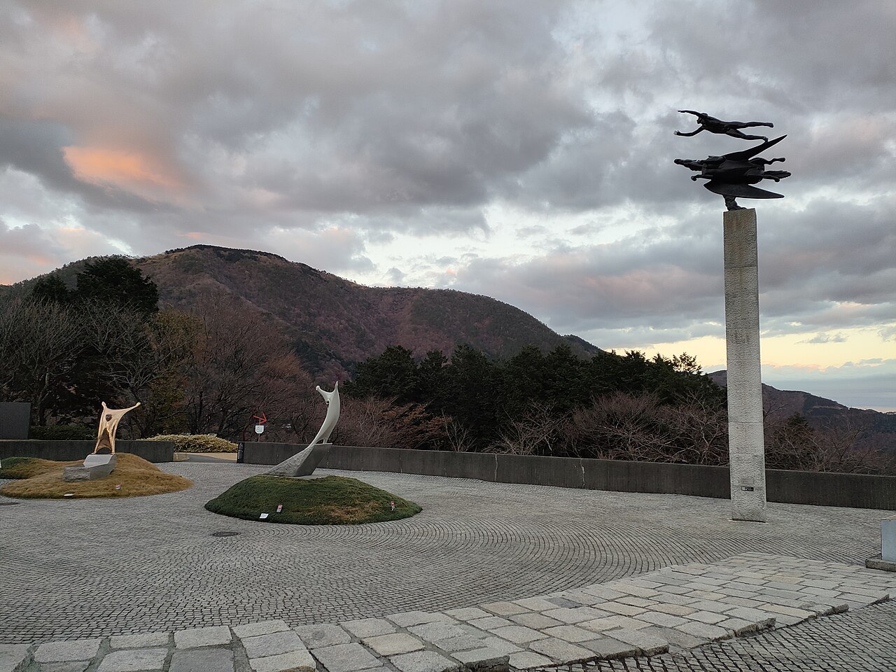 Visitors relaxing their feet in the natural hot spring foot bath at Hakone Open Air Museum.
