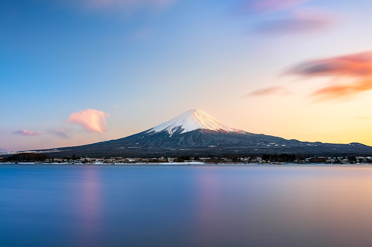 Mount Fuji seen majestically across Lake Ashi from a scenic viewpoint on the shore.