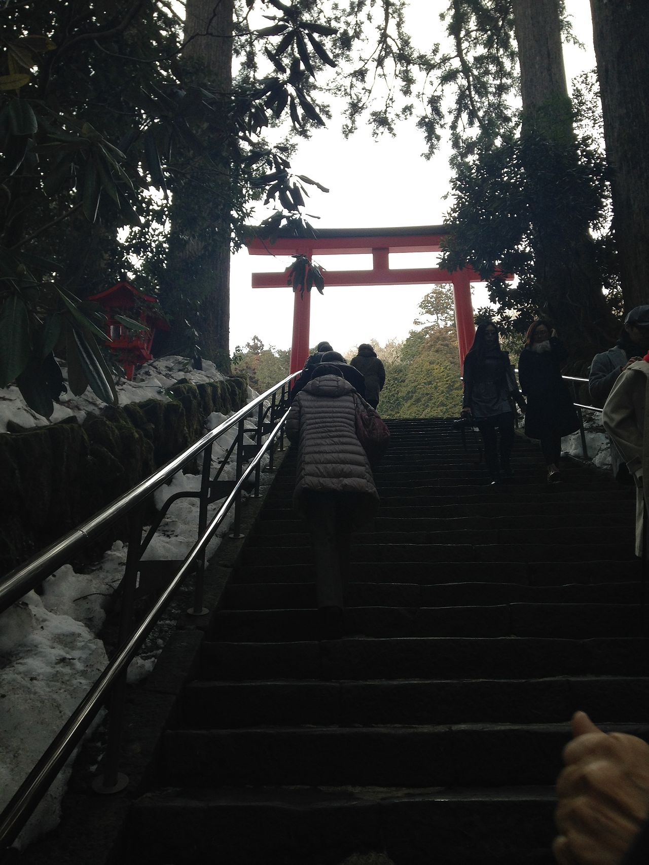 Red torii gate of Hakone Shrine standing in Lake Ashi