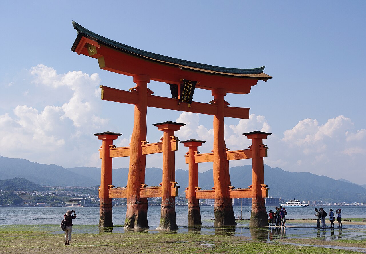 The iconic red floating torii gate of Itsukushima Shrine at high tide on Miyajima Island.