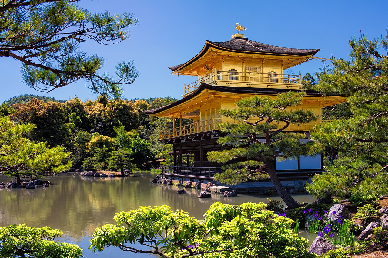 Close-up view of the golden facade of Kinkaku-ji, highlighting the intricate gold leaf and architectural details.