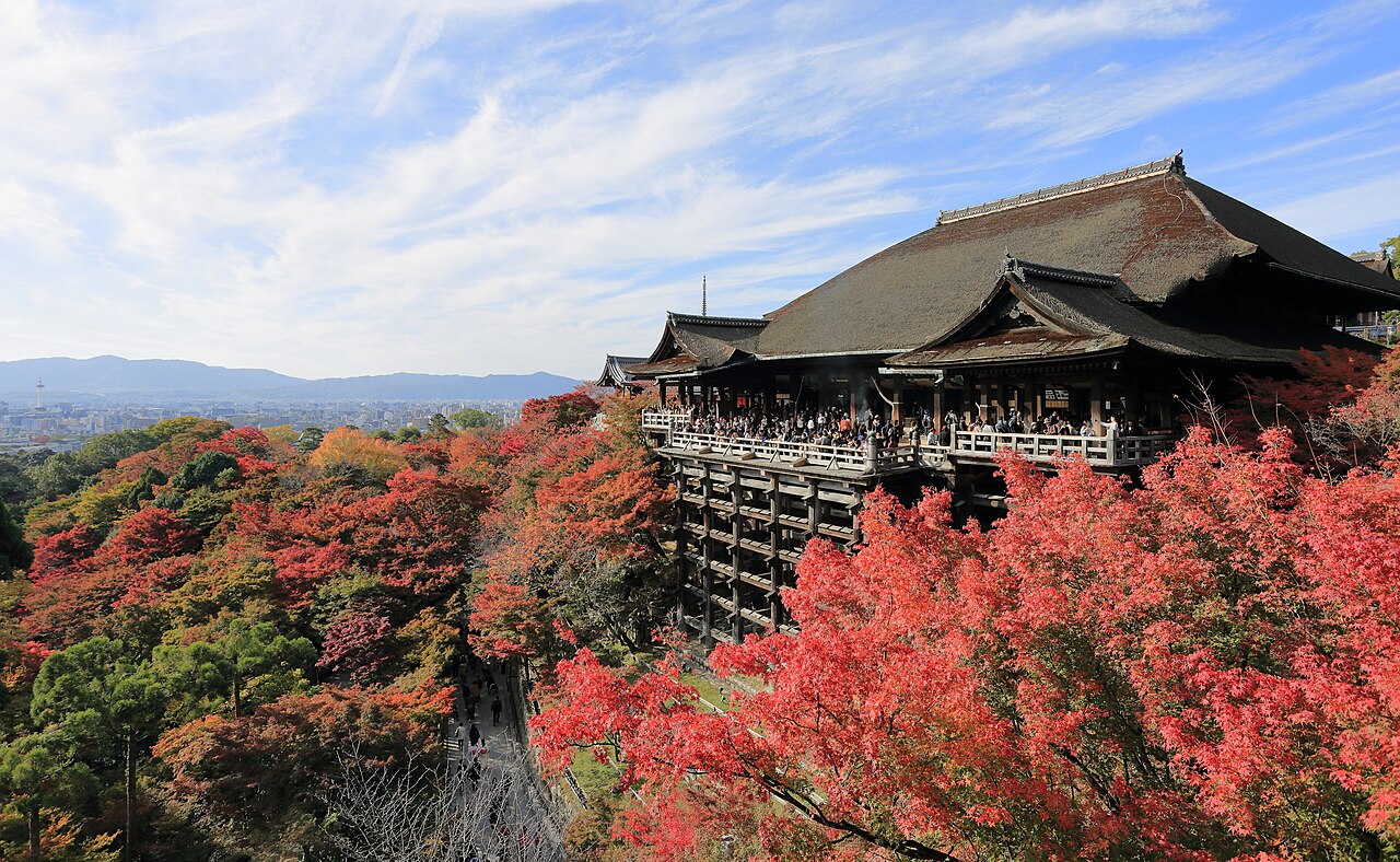 The iconic wooden stage of Kiyomizu-dera Main Hall overlooking autumn foliage
