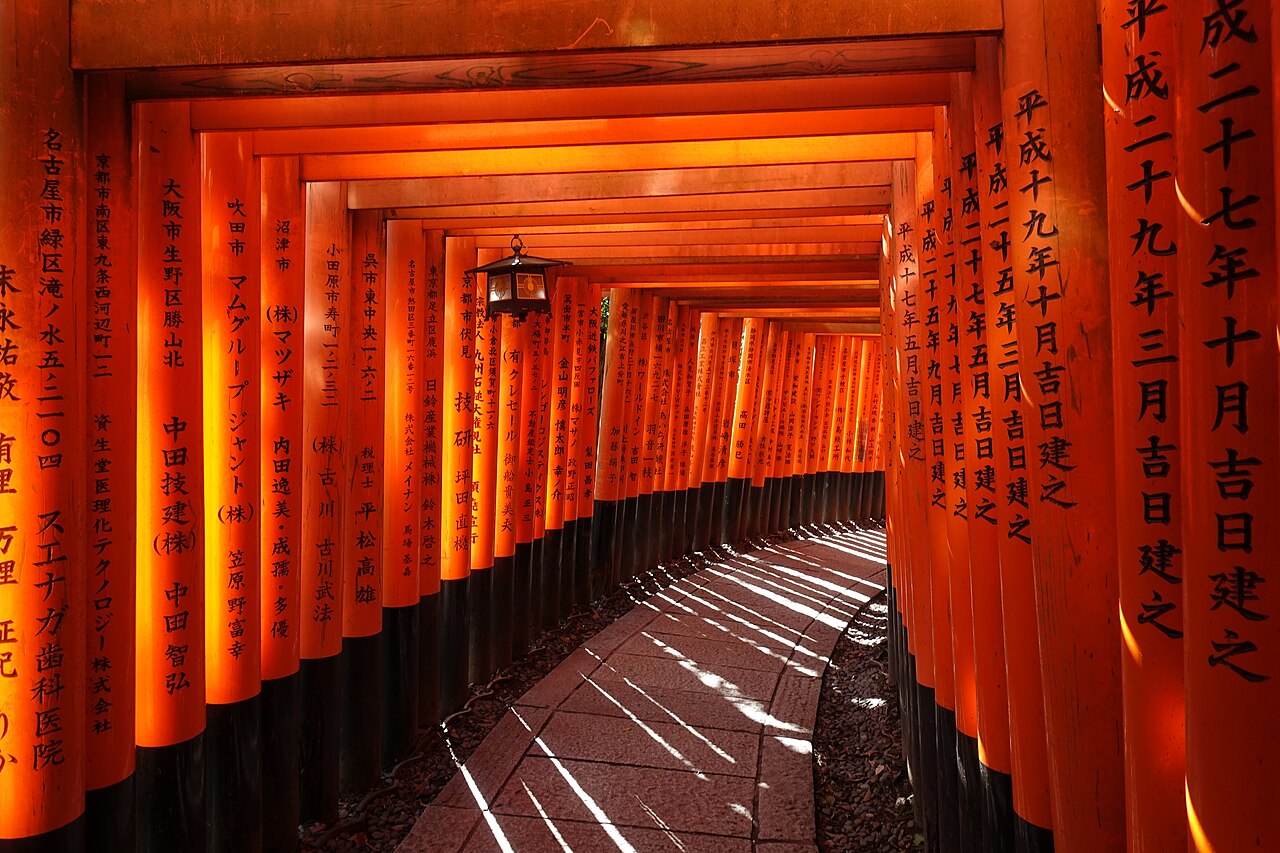 Iconic red torii gates winding up the mountain at Fushimi Inari Shrine.