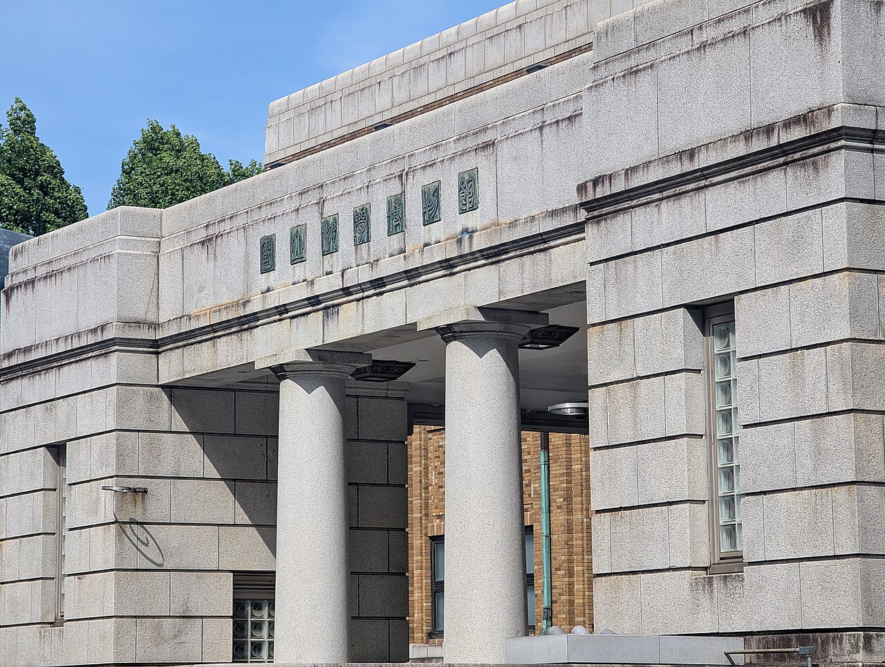 The red brick main building of the National Museum of Kyoto on a cloudy or rainy day.