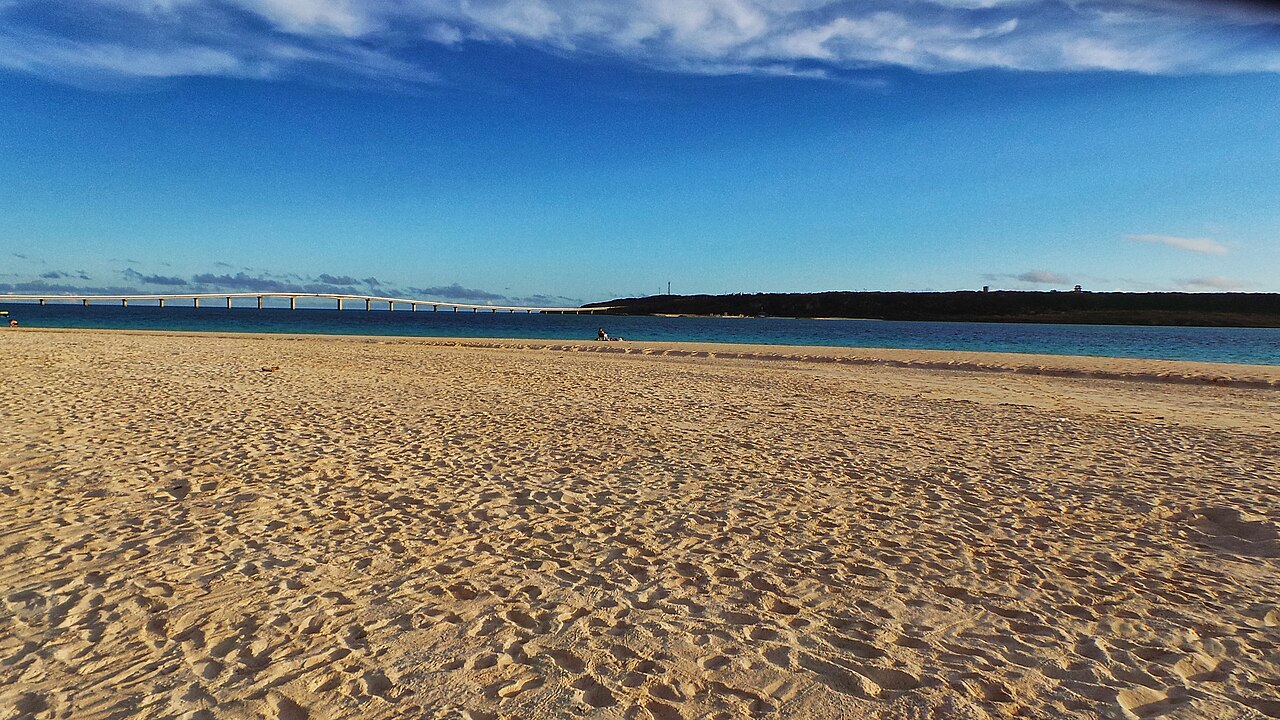 Expansive view of Yonaha Maehama Beach on Miyako Island with long stretch of white sand and calm blue sea
