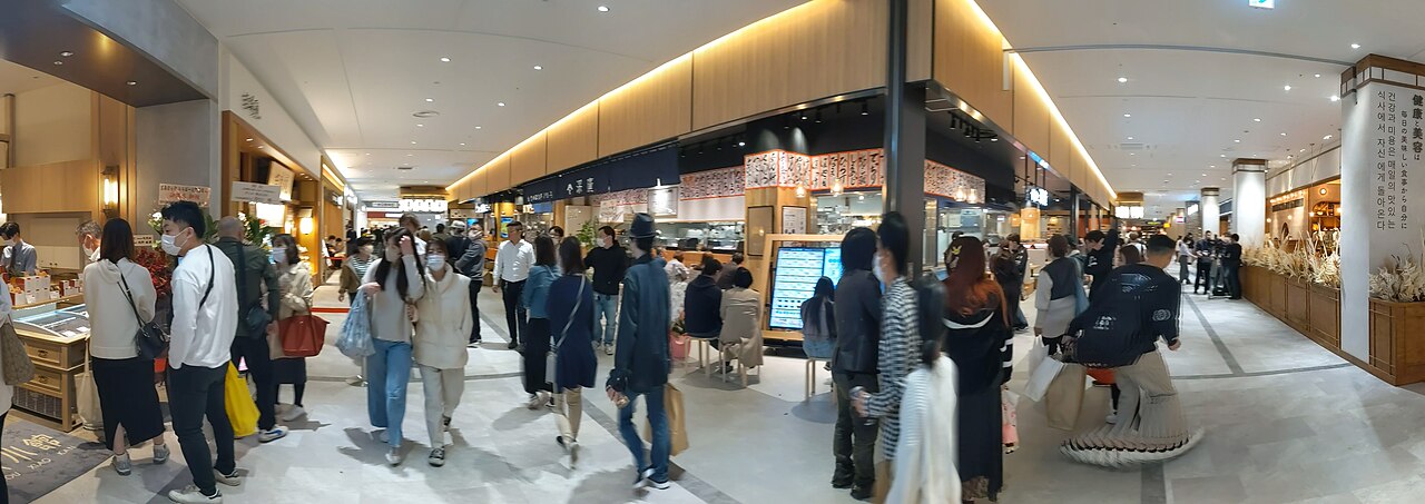 A vibrant platter of fresh sashimi, featuring various types of raw fish, commonly found at Kuromon Market.