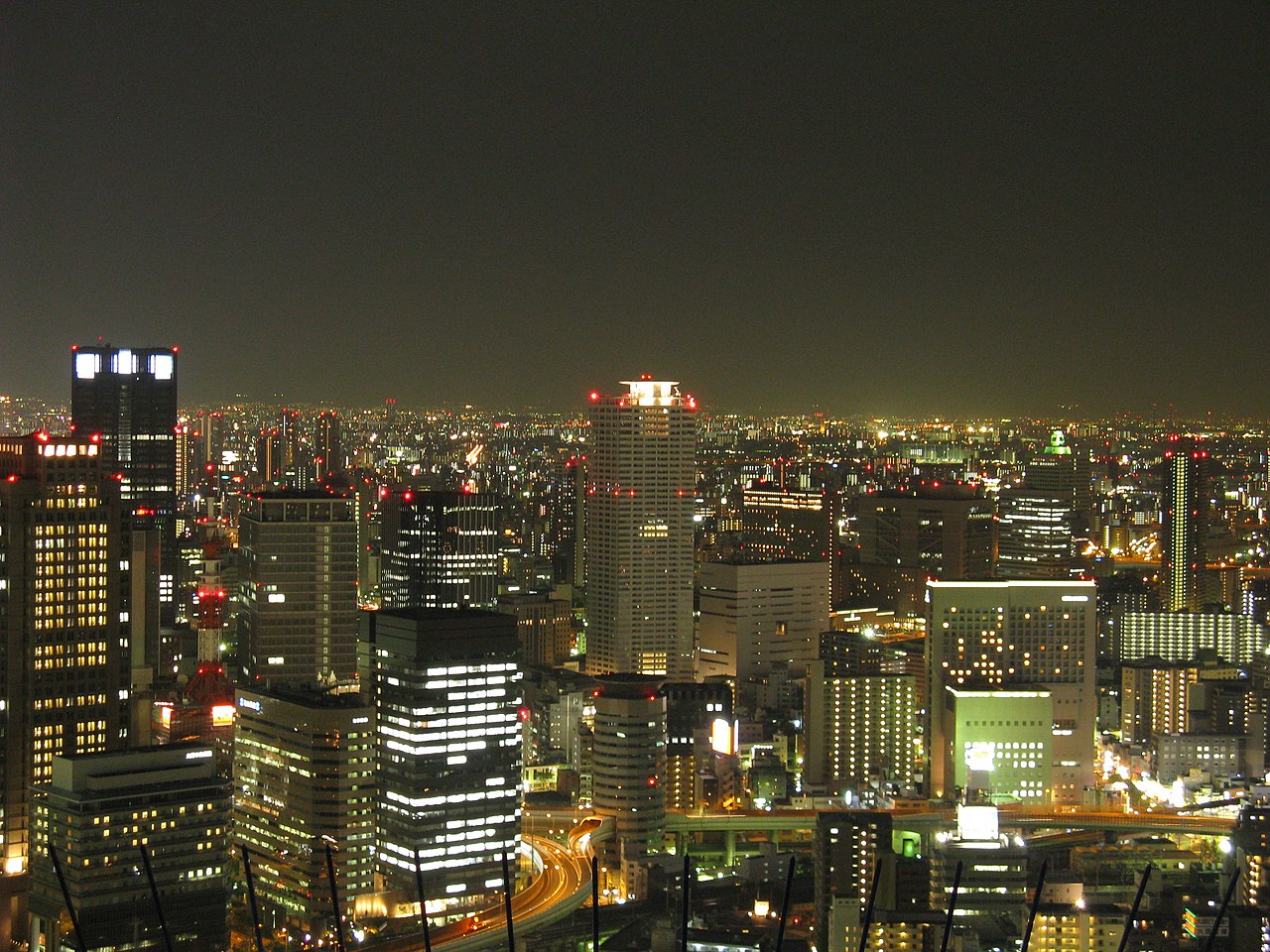 Panoramic night view of Osaka's Umeda district from a high-rise building