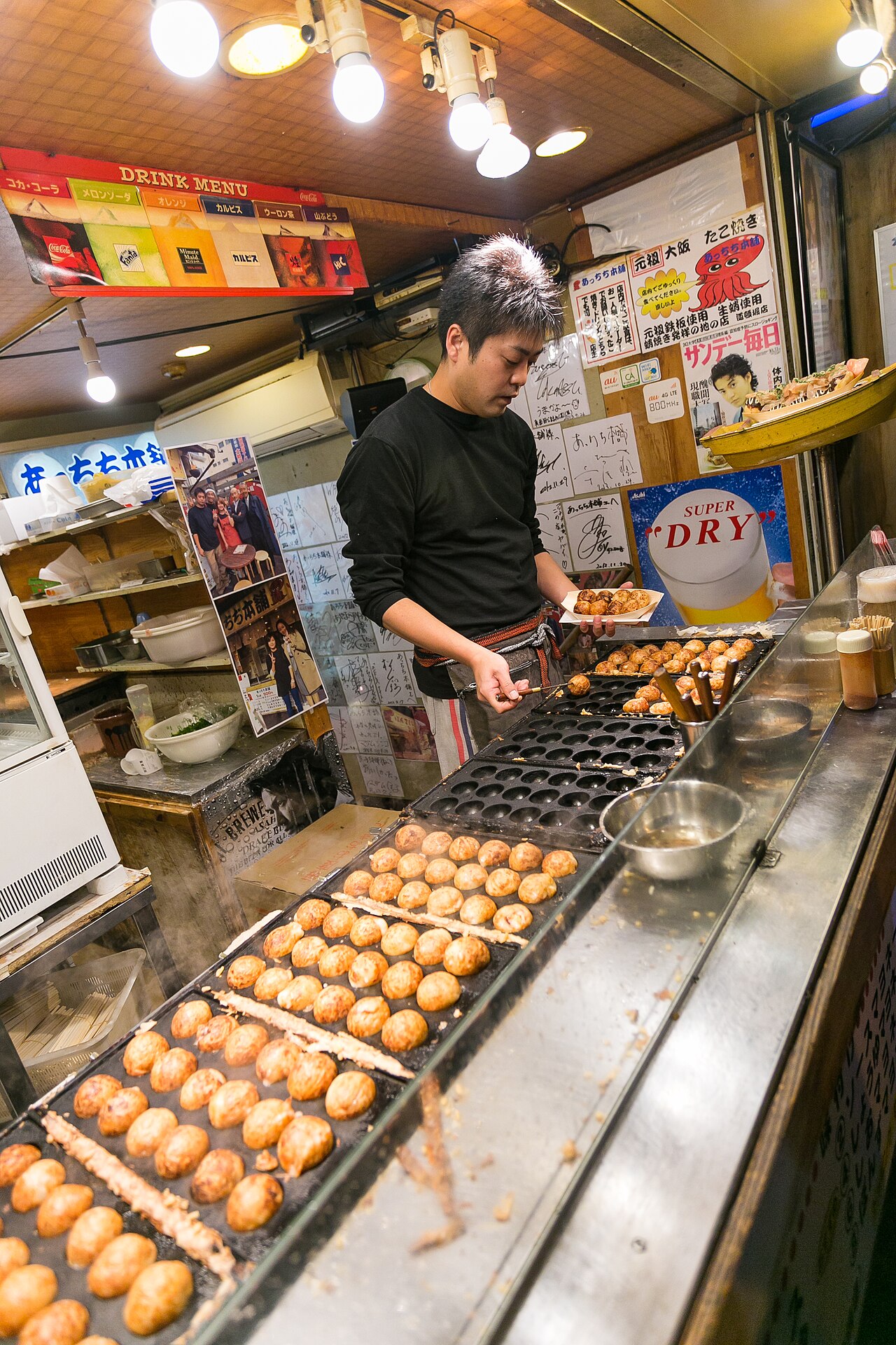 Freshly made takoyaki topped with sauce, mayonnaise, and bonito flakes