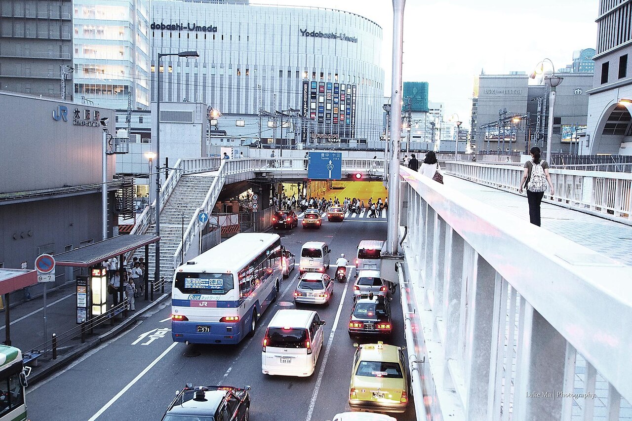 Bustling street scene with pedestrians and modern buildings in Umeda, Osaka
