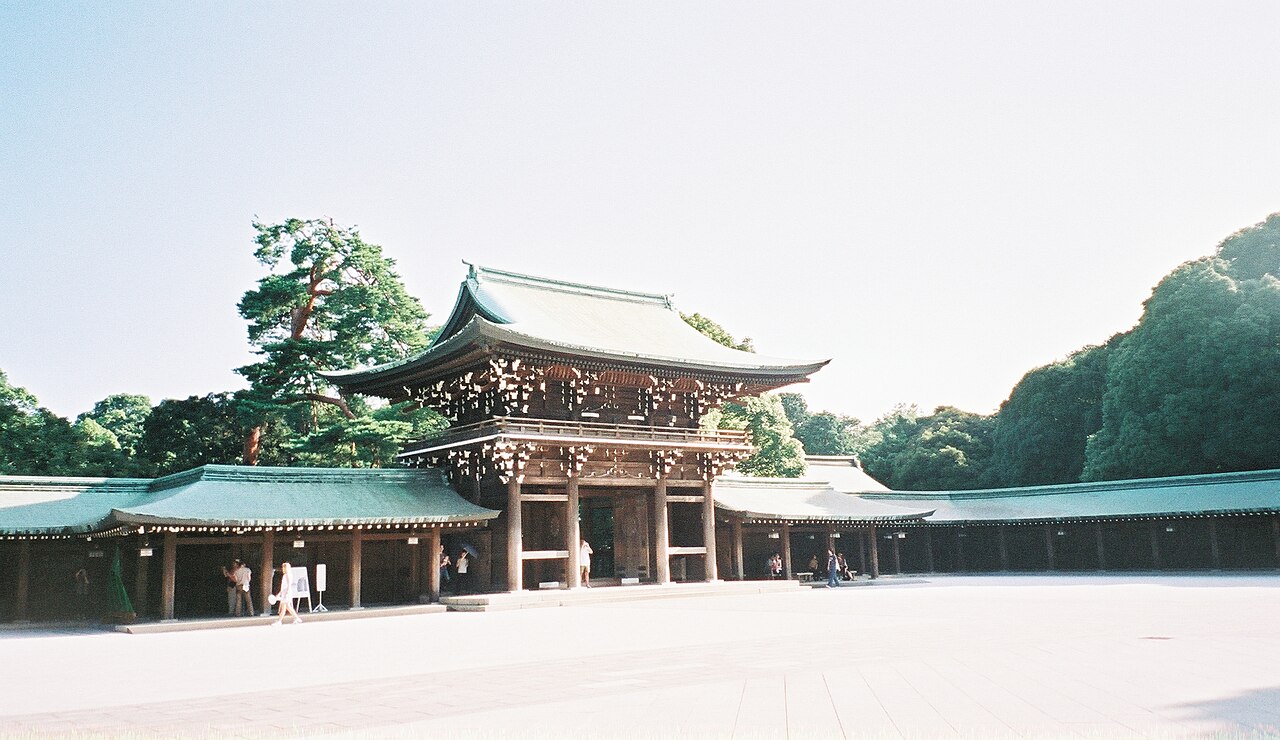 Grand wooden torii gate leading into the peaceful forest of Meiji Jingu Shrine