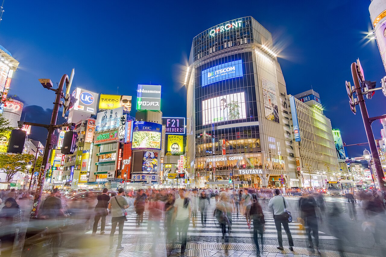 Aerial view of Shibuya Scramble Crossing with numerous pedestrians crossing