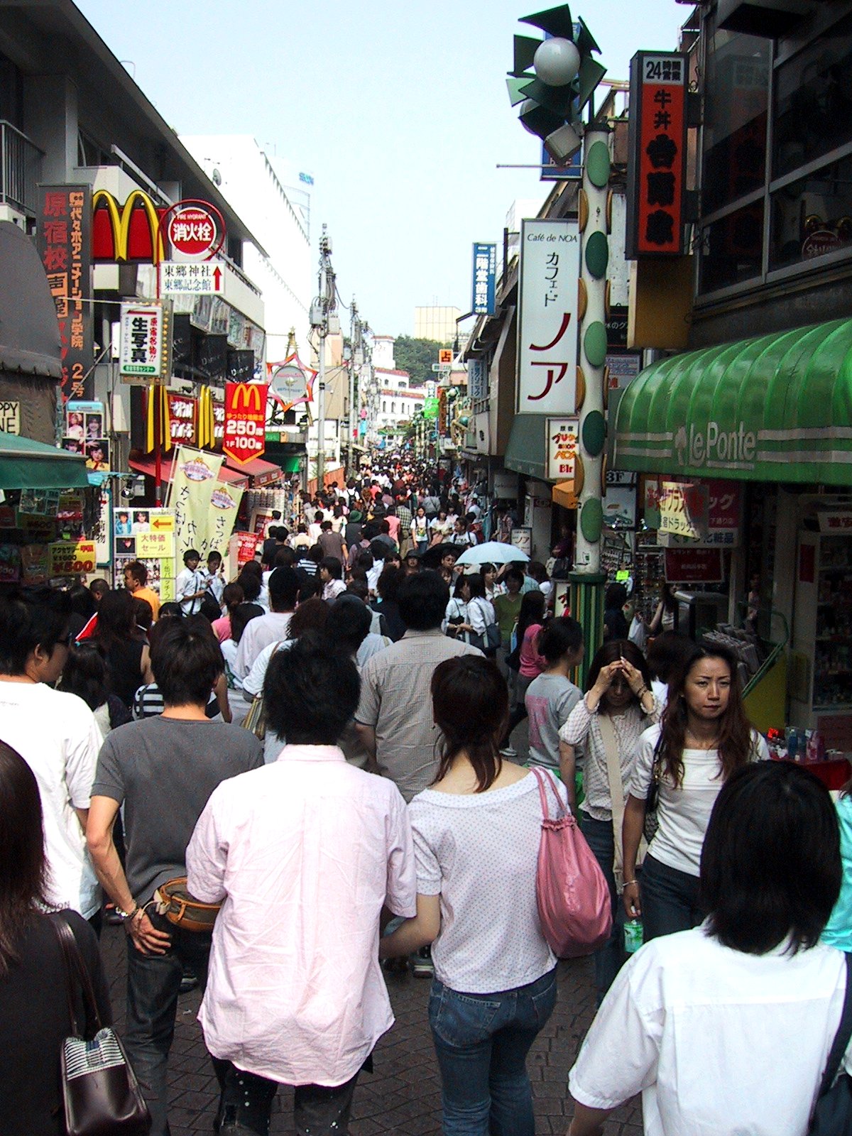 Crowded Takeshita Street in Harajuku, bustling with young people and colorful, unique fashion shops