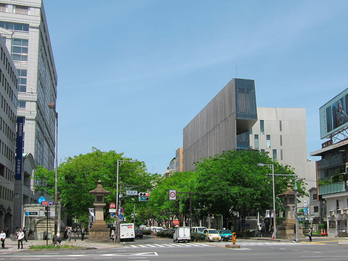 Tree-lined Omotesando avenue showcasing modern architectural designs of luxury brand stores