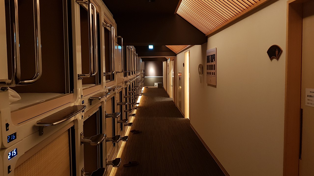 Interior view of a modern capsule hotel in Tokyo with multiple sleeping pods