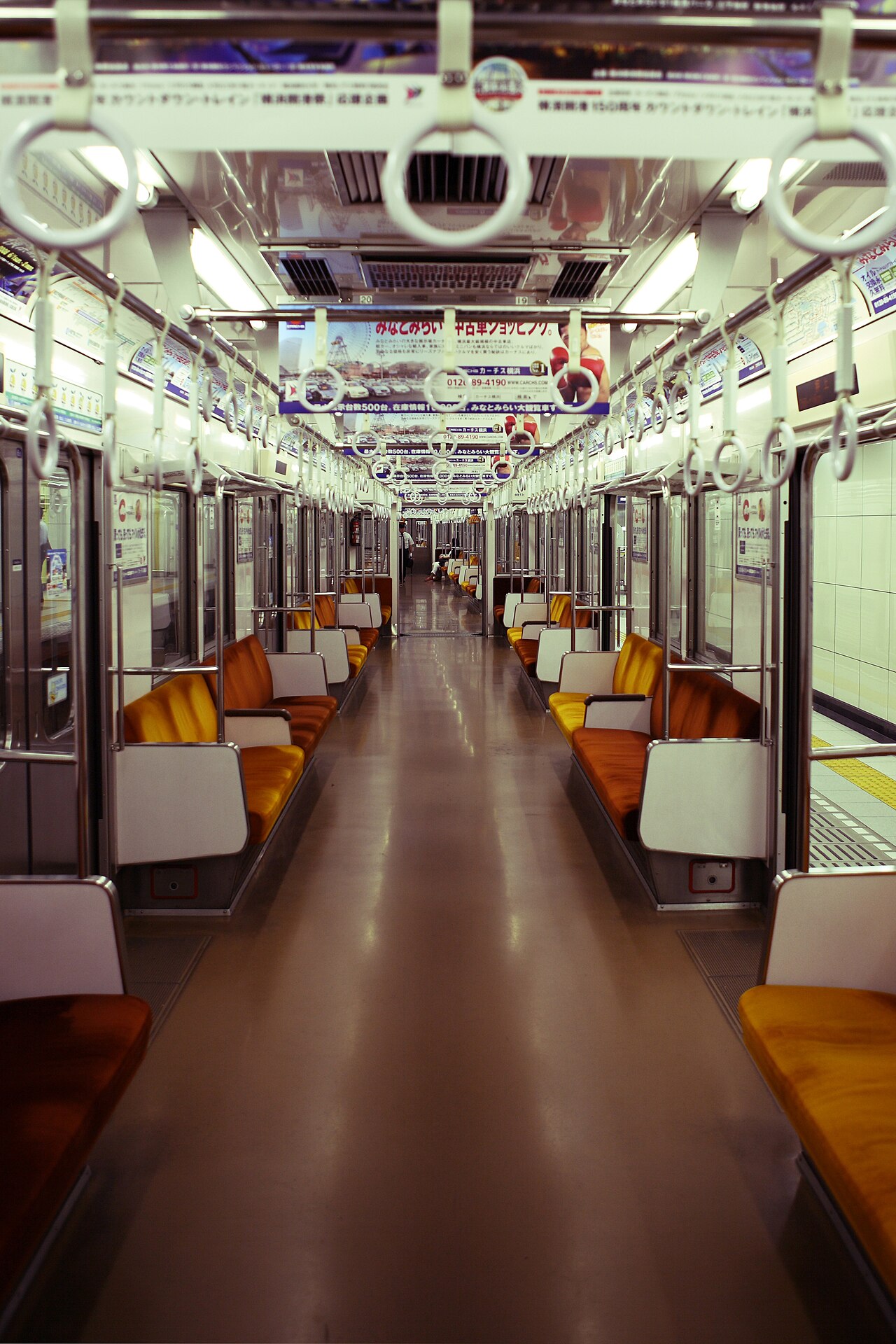 Interior of a clean Tokyo Metro train with passengers