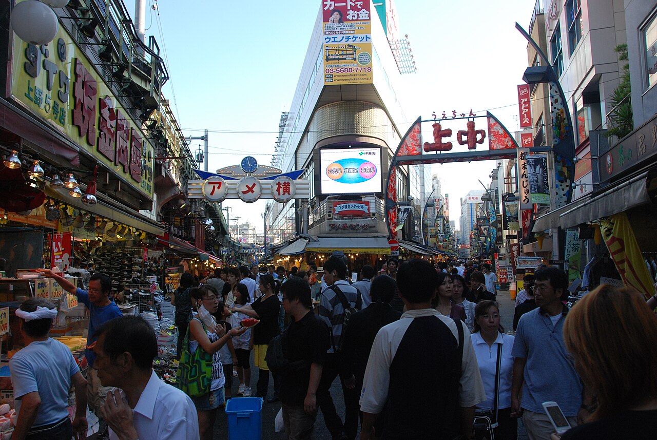 Bustling Ameyoko market street with various food stalls and shoppers